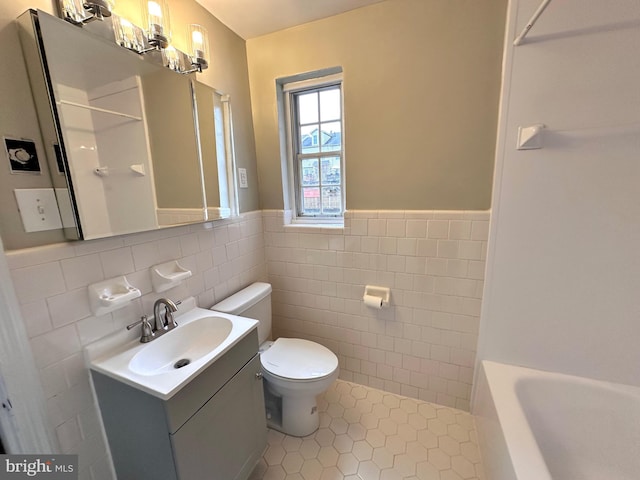 full bathroom featuring tile patterned flooring, tile walls, vanity, shower with separate bathtub, and toilet