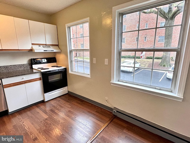 kitchen featuring a textured ceiling, electric range oven, a baseboard radiator, hardwood / wood-style flooring, and white cabinets