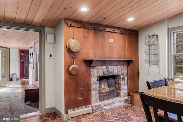 living room with a fireplace, a baseboard radiator, and wooden ceiling