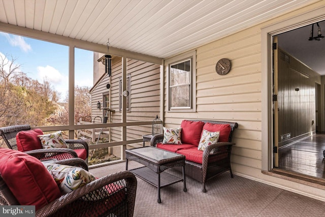 sunroom / solarium featuring wood ceiling