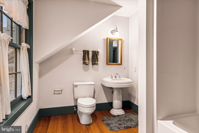 bathroom featuring sink, hardwood / wood-style floors, plenty of natural light, and toilet