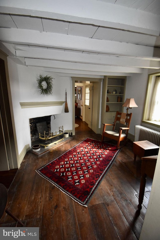 living room with beam ceiling, radiator, and hardwood / wood-style flooring