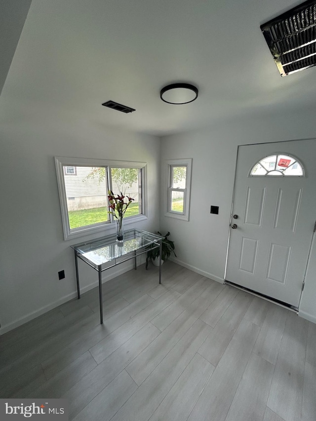 unfurnished office featuring light wood-type flooring