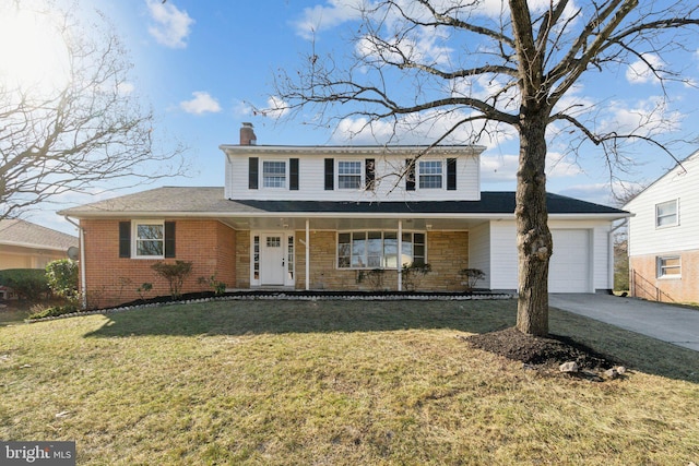 view of front of home with covered porch, a garage, and a front yard