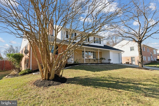 view of front facade with covered porch, a garage, and a front lawn