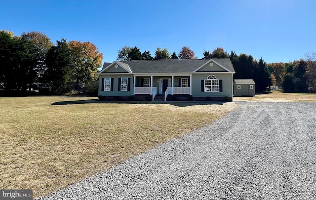 ranch-style home with covered porch and a front yard