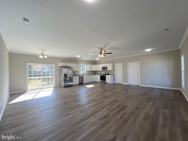 unfurnished living room featuring dark wood-type flooring, ceiling fan with notable chandelier, and ornamental molding