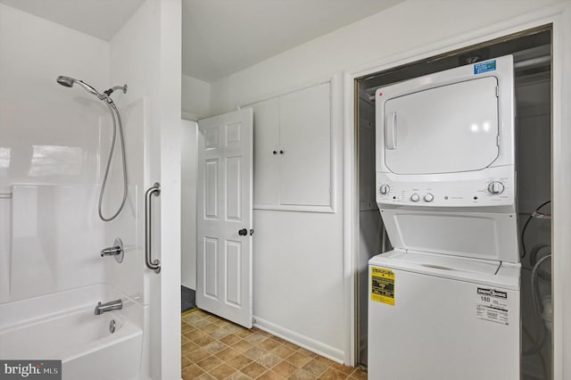 clothes washing area featuring stacked washer and dryer