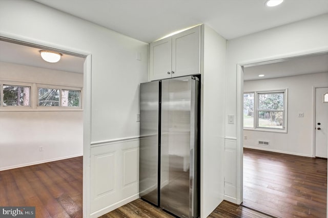 kitchen with stainless steel refrigerator and dark wood-type flooring