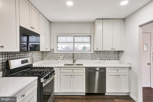 kitchen with white cabinets, dark hardwood / wood-style flooring, sink, and stainless steel appliances