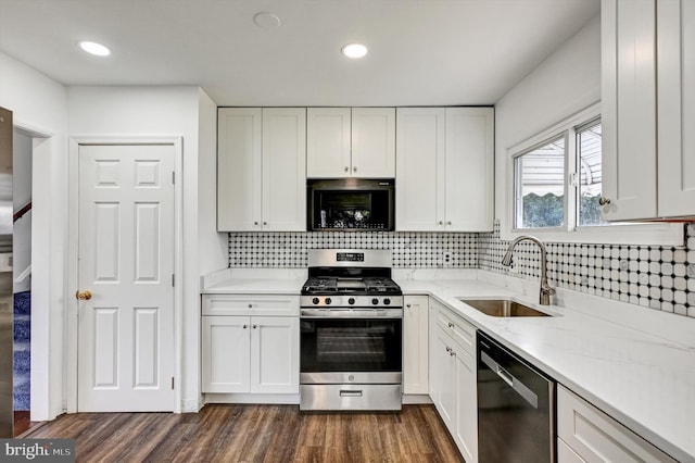 kitchen featuring dark hardwood / wood-style floors, white cabinetry, and stainless steel appliances