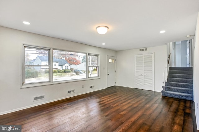 interior space featuring a healthy amount of sunlight and dark hardwood / wood-style floors