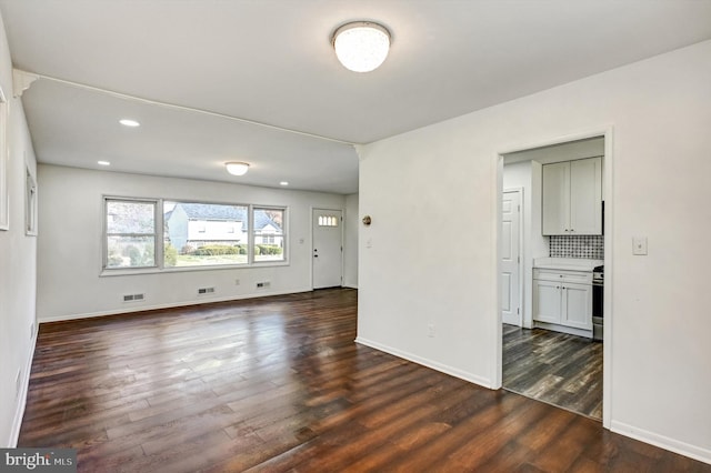 spare room with dark wood-type flooring