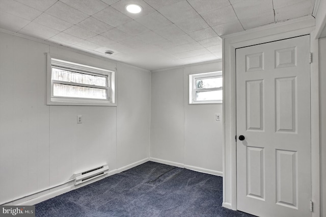 carpeted empty room featuring a baseboard radiator