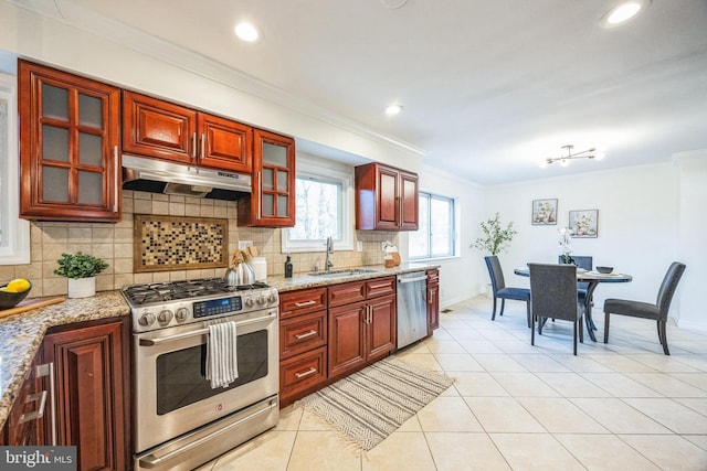 kitchen featuring sink, ornamental molding, light tile patterned floors, stainless steel appliances, and light stone countertops