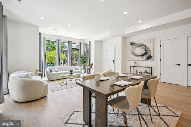 dining space with light hardwood / wood-style flooring