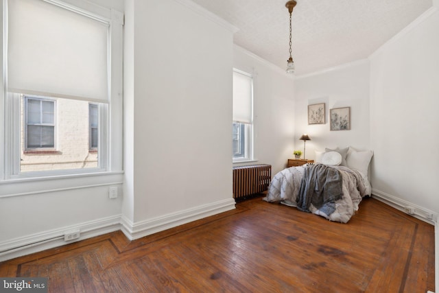 unfurnished bedroom with radiator, crown molding, dark hardwood / wood-style flooring, and a textured ceiling