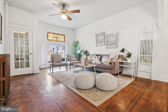 living room featuring ceiling fan and dark hardwood / wood-style flooring