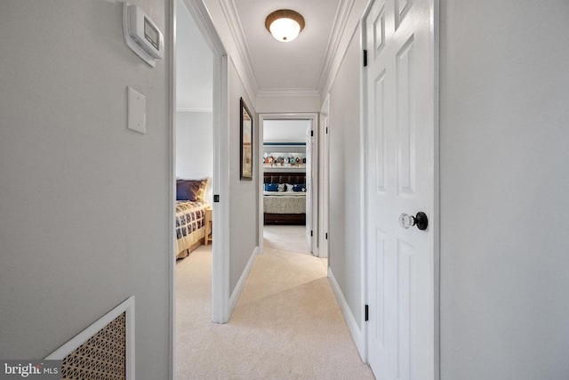 hall featuring light colored carpet and crown molding