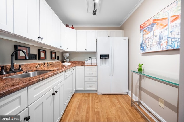 kitchen featuring light wood-type flooring, ornamental molding, white appliances, sink, and white cabinetry