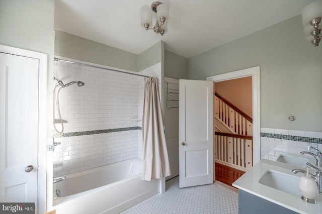 bathroom featuring shower / bath combo, tile walls, and vanity