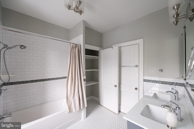 bathroom with sink, shower / bath combo, and tile walls