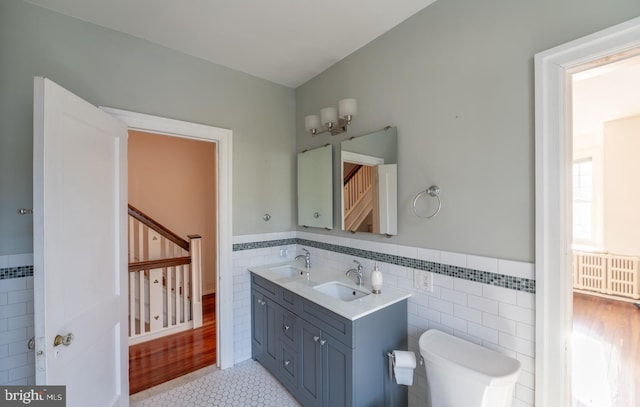 bathroom with tile patterned floors, vanity, toilet, and tile walls