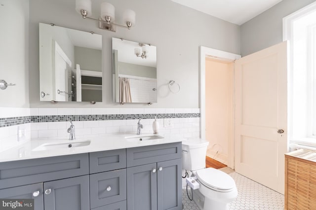 bathroom featuring tile patterned floors, vanity, and toilet