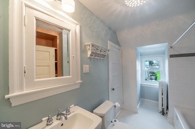 bathroom featuring tile patterned floors, toilet, and radiator heating unit