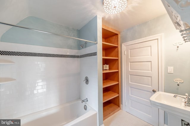 bathroom with bathtub / shower combination, tile patterned flooring, and sink