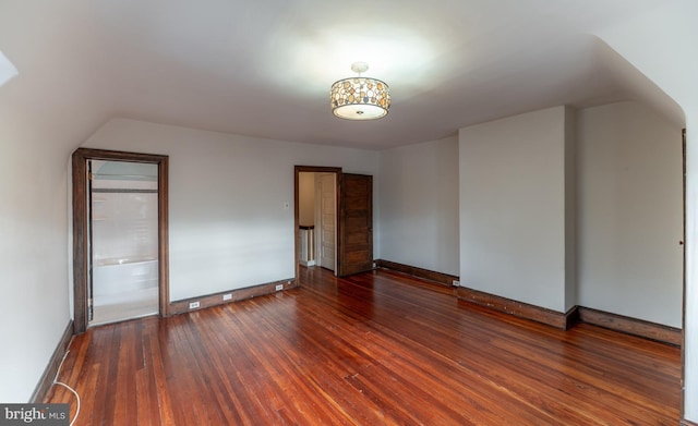 additional living space with dark hardwood / wood-style flooring