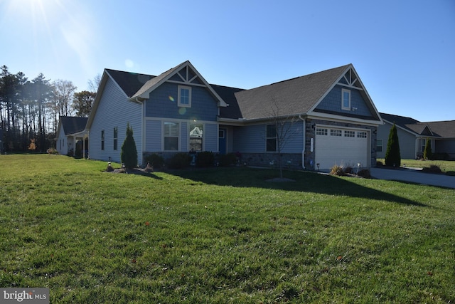 view of front of home with a front lawn and a garage