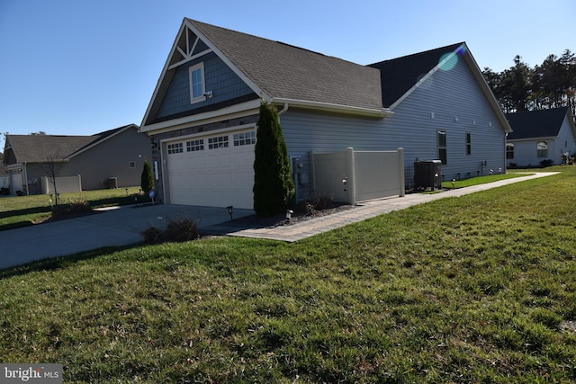 view of home's exterior with a lawn, central air condition unit, and a garage