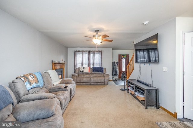 carpeted living room featuring ceiling fan