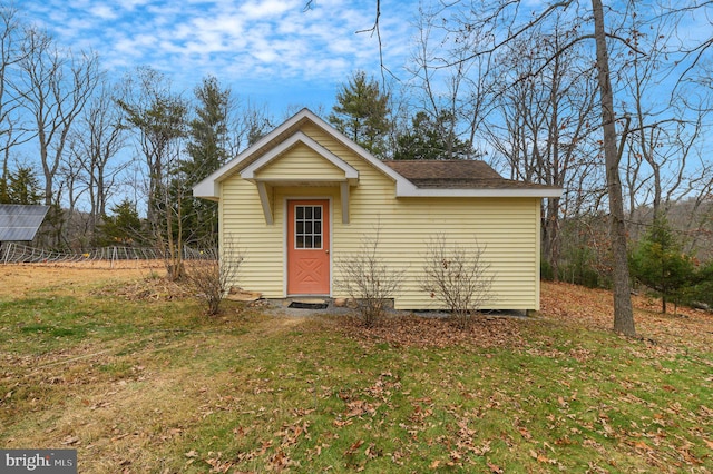 view of outbuilding with a lawn