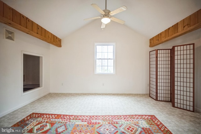 unfurnished living room with ceiling fan, light colored carpet, and lofted ceiling