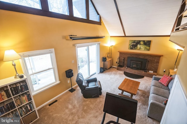 carpeted living room featuring high vaulted ceiling, a fireplace, and a wealth of natural light