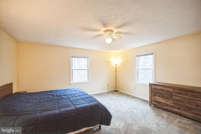 bedroom with carpet flooring, multiple windows, and ceiling fan