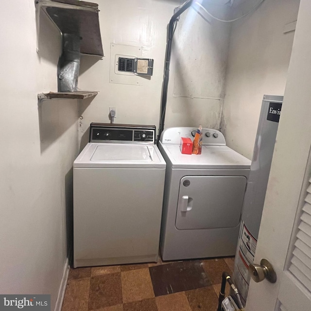 laundry room with water heater and independent washer and dryer