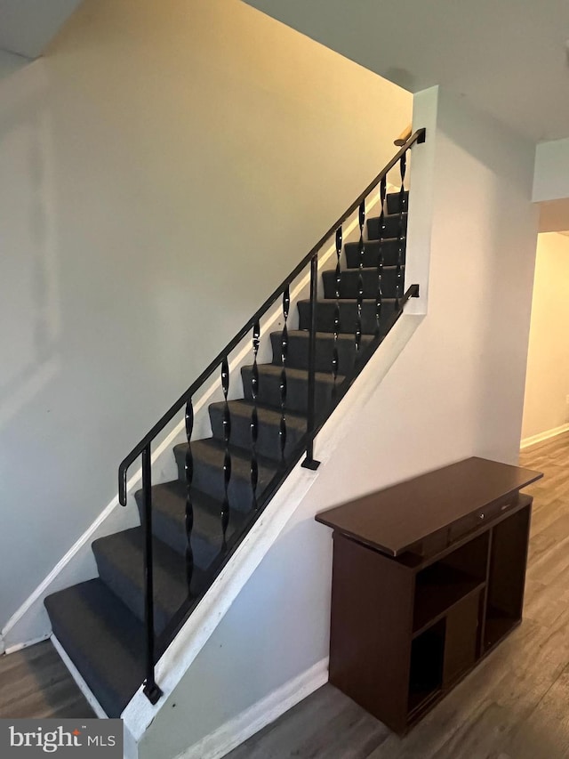 stairway featuring hardwood / wood-style floors