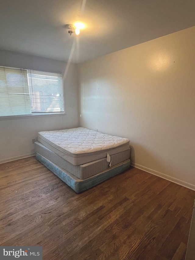 bedroom featuring dark wood-type flooring