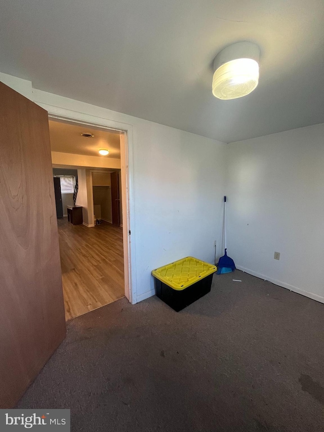 unfurnished room with wood-type flooring