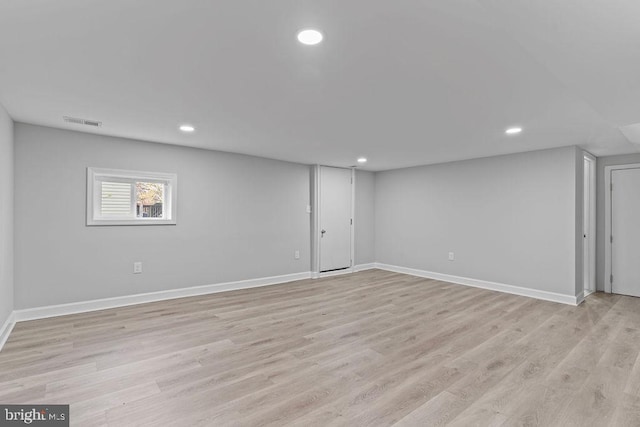 basement with light hardwood / wood-style flooring