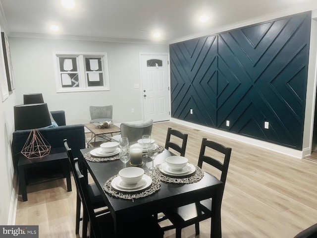 dining room with hardwood / wood-style flooring and ornamental molding