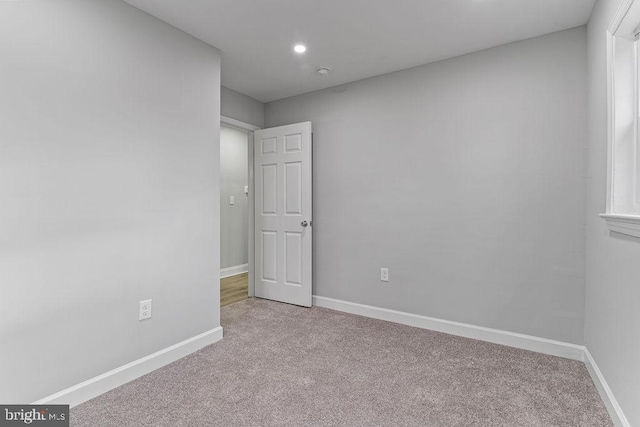 spare room with light colored carpet