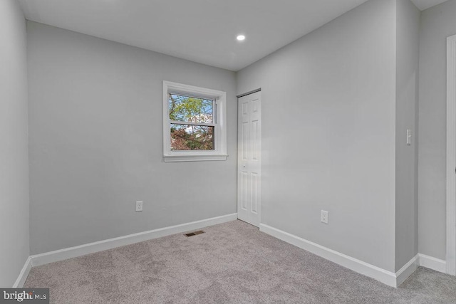 spare room with light colored carpet