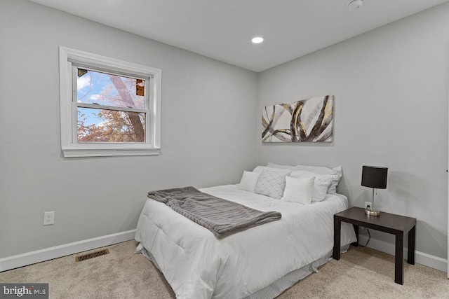 bedroom with light colored carpet