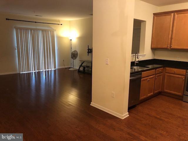 kitchen with black dishwasher, dark hardwood / wood-style floors, and sink