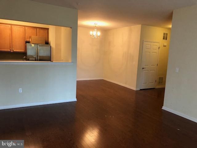 interior space featuring a chandelier and dark hardwood / wood-style flooring