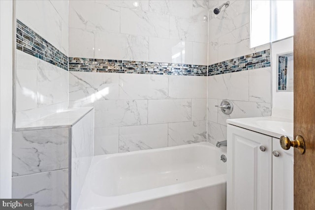 bathroom with vanity and tiled shower / bath